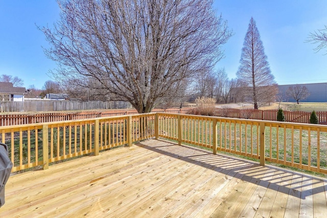 wooden deck with a fenced backyard