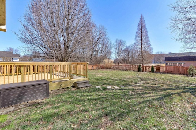 view of yard with a deck and fence