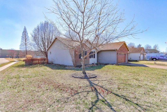 view of front of property featuring brick siding, an attached garage, a front lawn, and fence