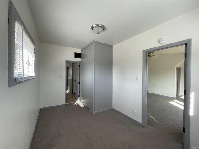 carpeted spare room with baseboards