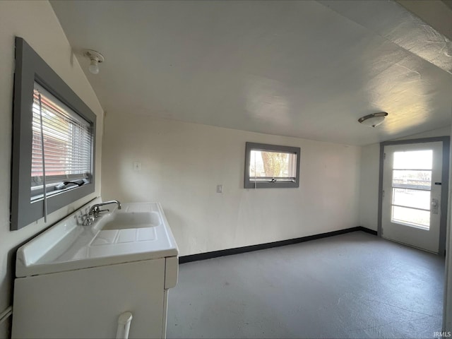 laundry area featuring plenty of natural light, baseboards, and a sink