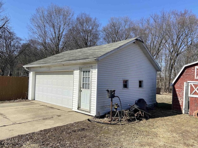 detached garage featuring fence