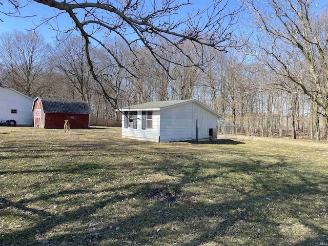 view of yard with a storage shed and an outbuilding