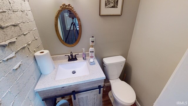 bathroom featuring toilet and vanity