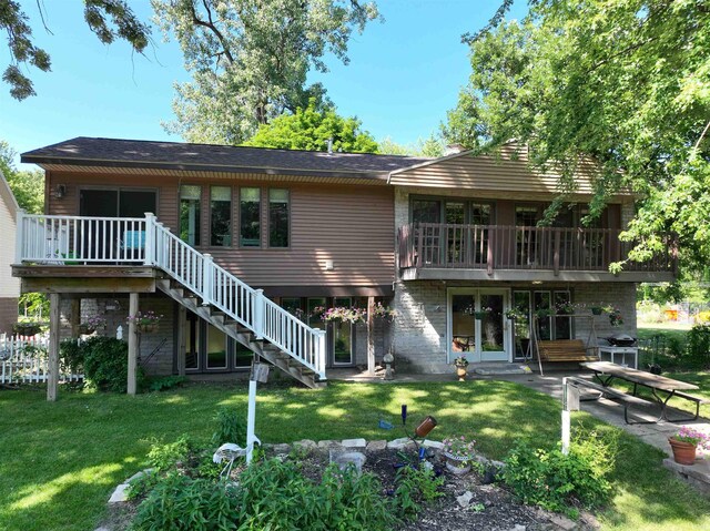 back of property with a patio area, stairway, and a yard