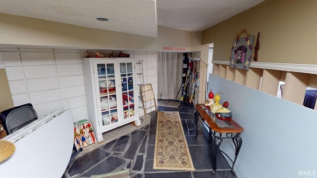 interior space featuring french doors and a textured ceiling