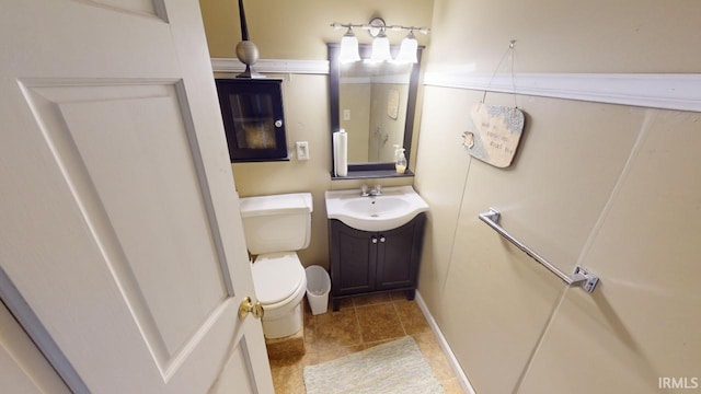 bathroom featuring toilet and vanity