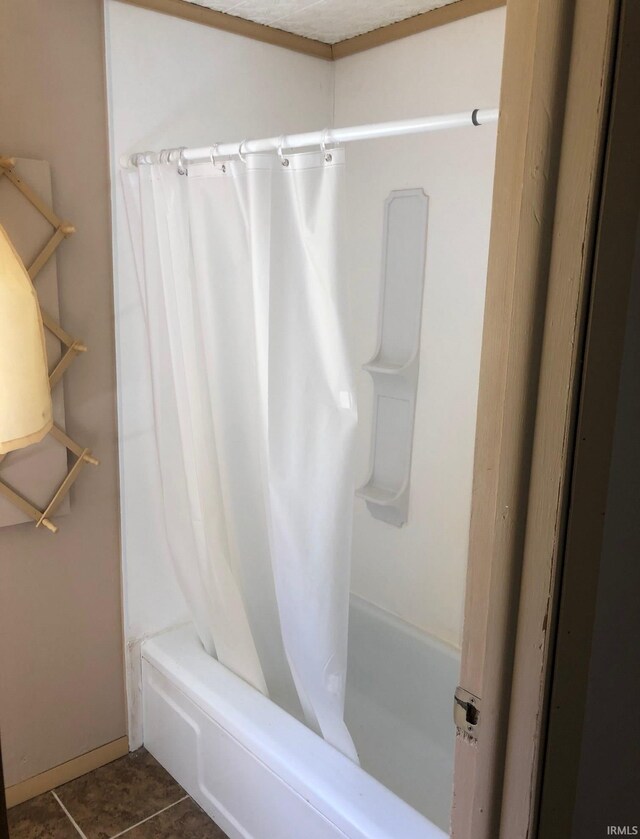 full bath featuring tile patterned flooring and shower / bathtub combination with curtain