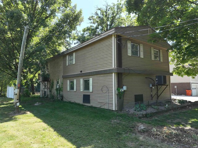 view of side of home with a yard