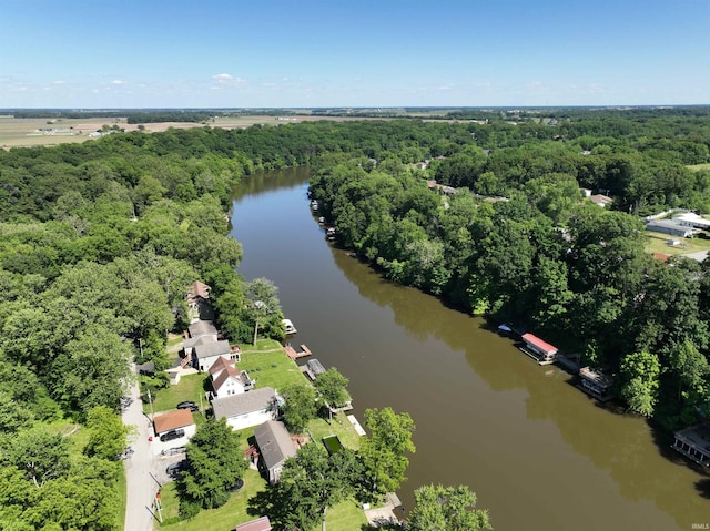 aerial view featuring a forest view and a water view