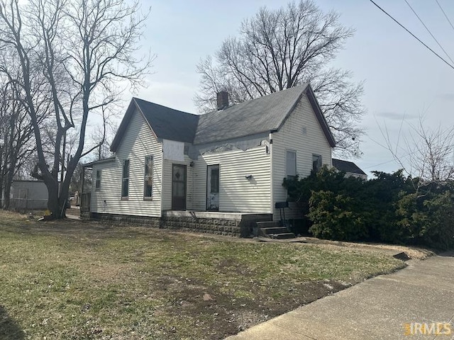 view of front of property with a front lawn and a chimney