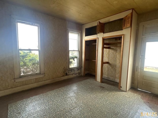 unfurnished bedroom featuring multiple closets