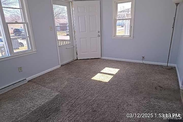 unfurnished room featuring a wealth of natural light, speckled floor, and baseboards