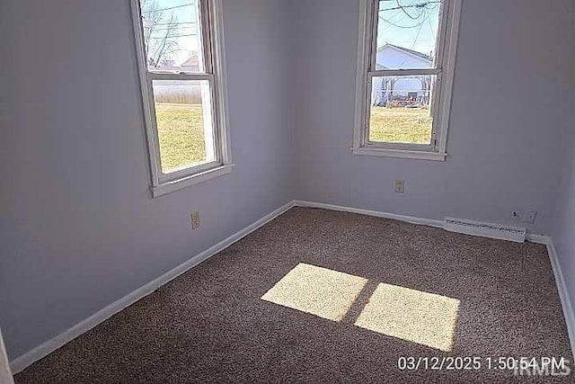 empty room featuring plenty of natural light, carpet, and baseboards