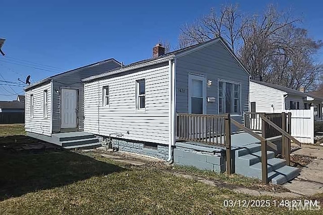 exterior space with entry steps and a chimney