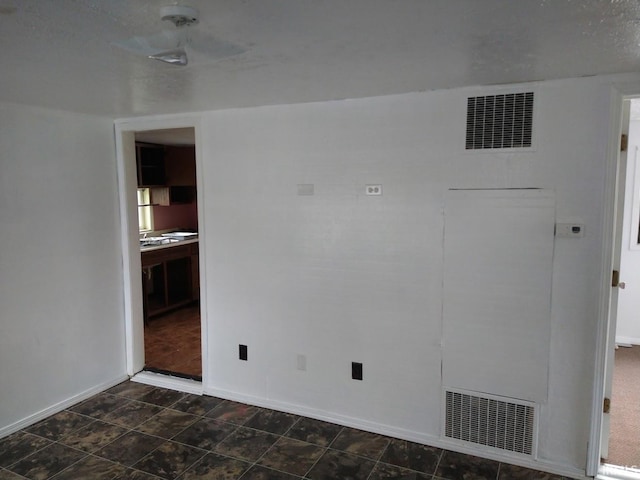 unfurnished room with visible vents and baseboards