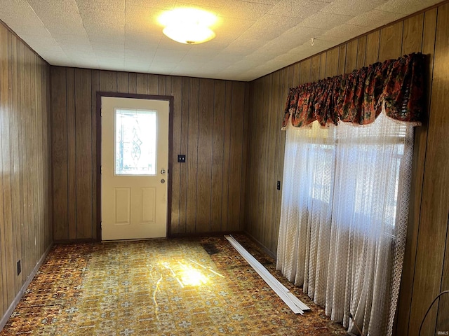 entryway with wooden walls