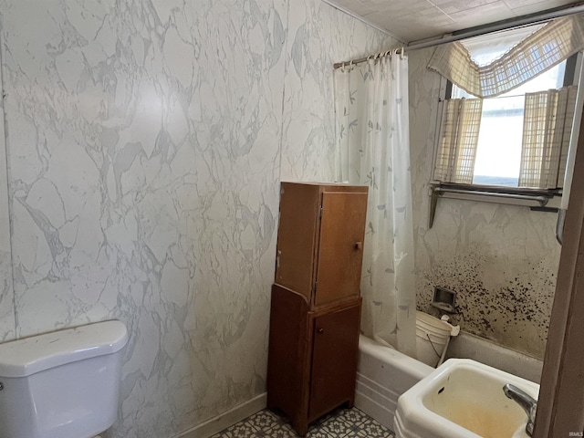 full bathroom with toilet, shower / tub combo, and a sink