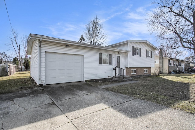 split level home with an attached garage, concrete driveway, and entry steps