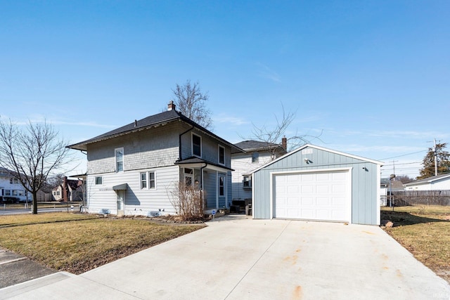 view of front facade featuring a front yard, an outdoor structure, driveway, and fence