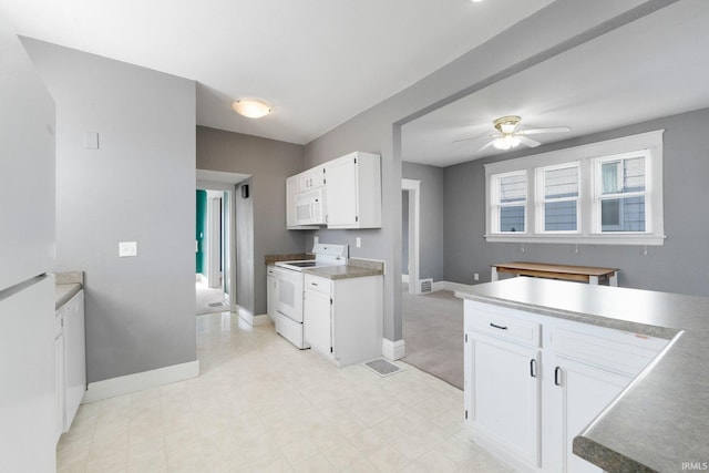 kitchen with ceiling fan, baseboards, white appliances, and white cabinets