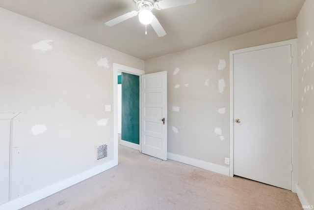 interior space with visible vents, carpet flooring, a ceiling fan, and baseboards