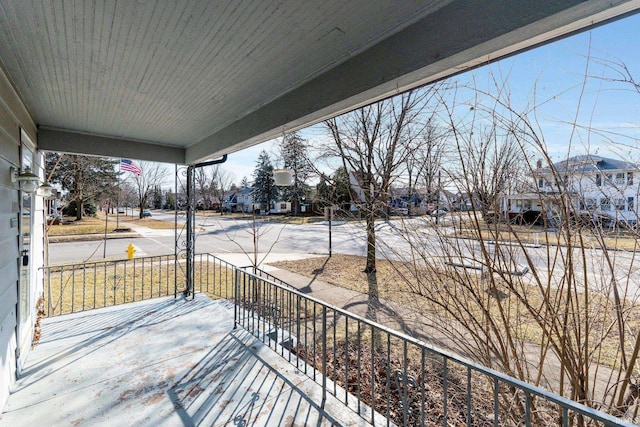 wooden deck with a porch and a residential view