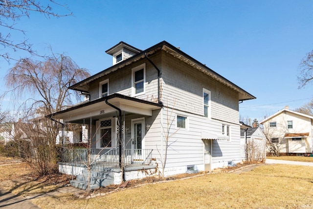 view of side of property featuring a lawn and a porch