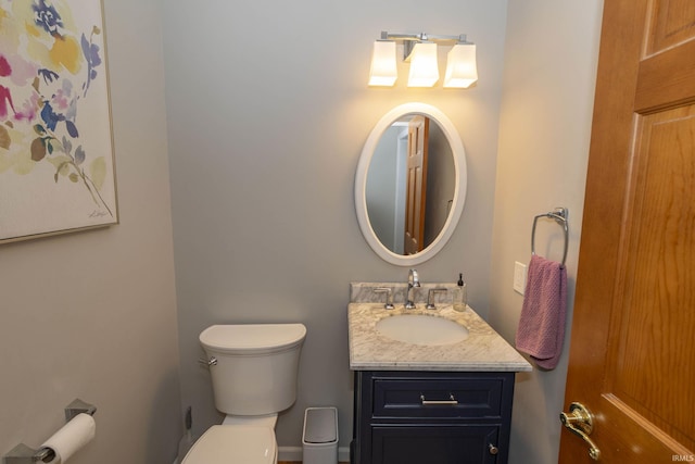 bathroom featuring toilet and vanity