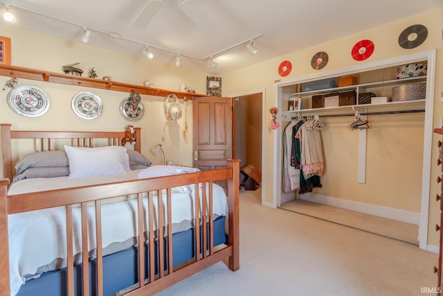 bedroom featuring a closet, light colored carpet, and a ceiling fan