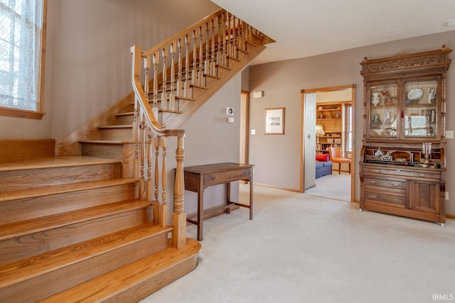 stairs featuring visible vents, baseboards, and carpet