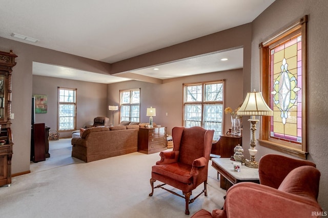 living room featuring recessed lighting, visible vents, and light colored carpet