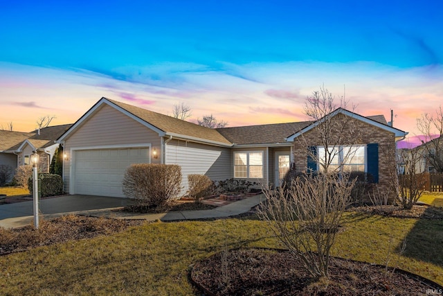 single story home featuring a garage, a front yard, roof with shingles, and driveway