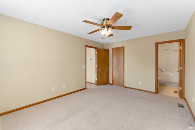 unfurnished bedroom with visible vents, light colored carpet, baseboards, and connected bathroom