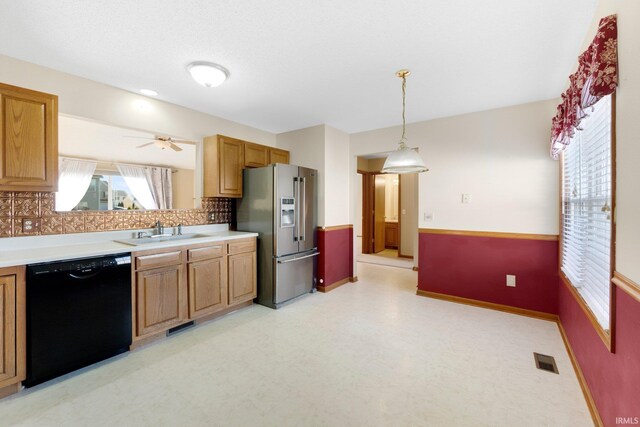 kitchen featuring visible vents, a sink, stainless steel fridge with ice dispenser, light floors, and dishwasher