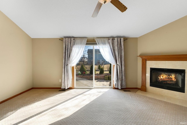 unfurnished living room featuring carpet flooring, baseboards, visible vents, and a tile fireplace