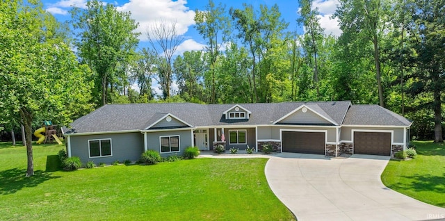 view of front of house featuring stone siding, a front lawn, concrete driveway, and an attached garage