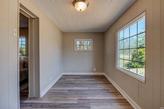 unfurnished room featuring wood finished floors and baseboards