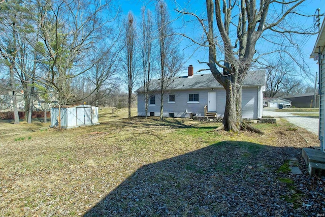 view of yard featuring an outbuilding, a shed, and entry steps