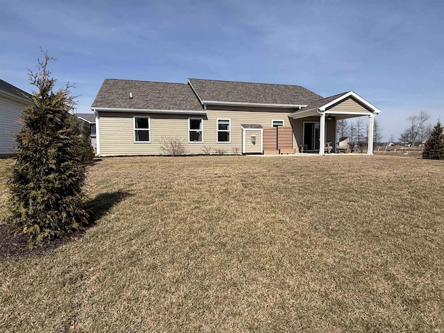 back of property featuring a patio and a yard