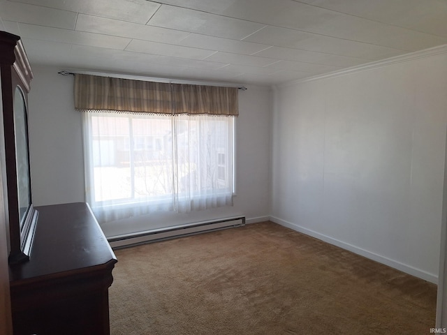 carpeted spare room with a baseboard heating unit, baseboards, and ornamental molding