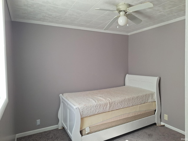 carpeted bedroom featuring a ceiling fan, baseboards, and ornamental molding