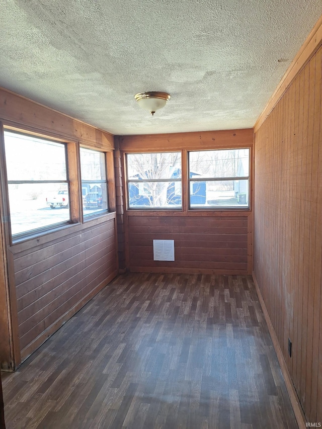 unfurnished sunroom featuring plenty of natural light and visible vents