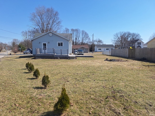 view of yard featuring fence and a wooden deck