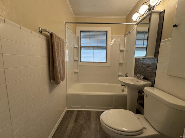 bathroom with wood finished floors, toilet, tile walls, and ornamental molding