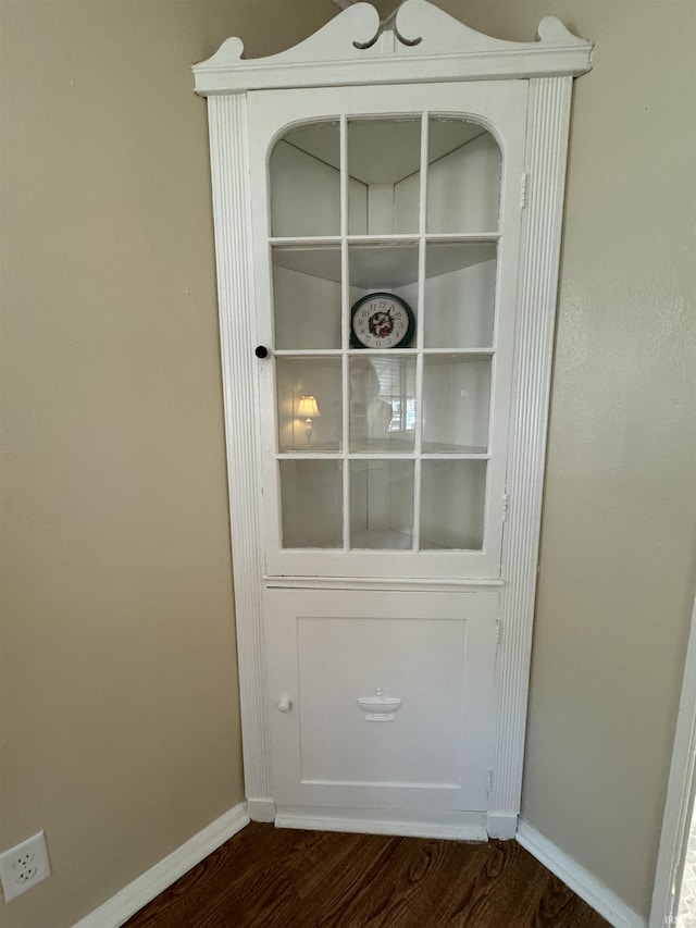 interior details featuring baseboards and wood finished floors