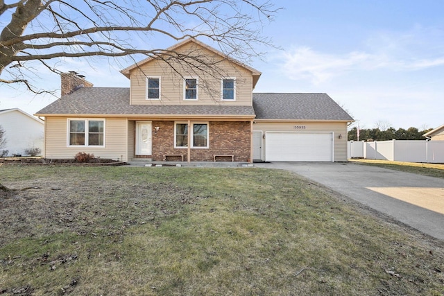 traditional home with a front lawn, fence, concrete driveway, an attached garage, and a chimney