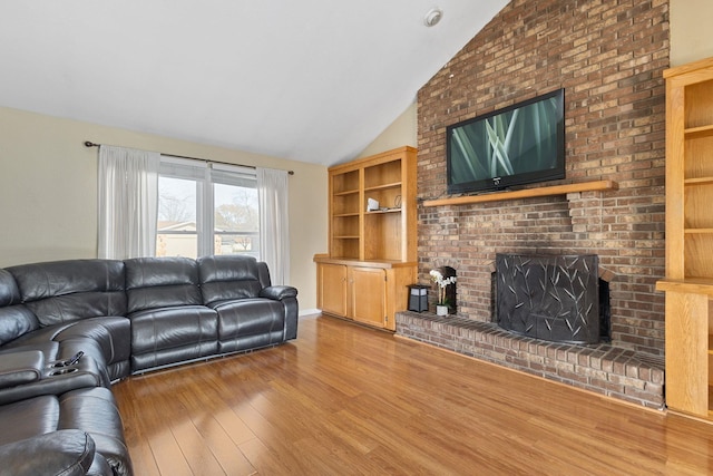 living room with a fireplace, baseboards, lofted ceiling, and wood finished floors