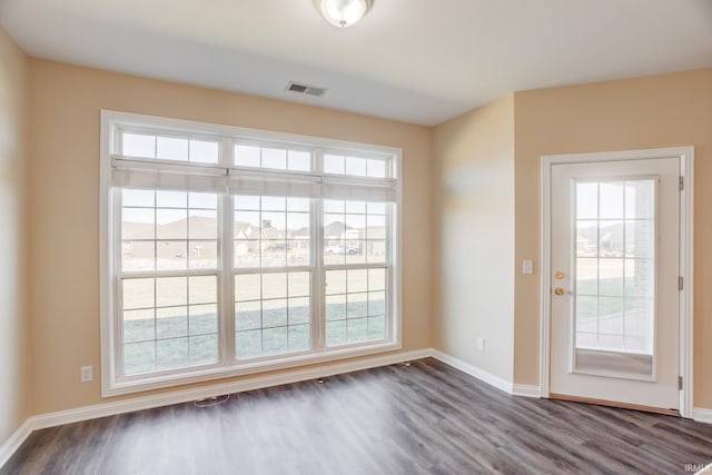 interior space featuring visible vents, baseboards, and dark wood-style flooring