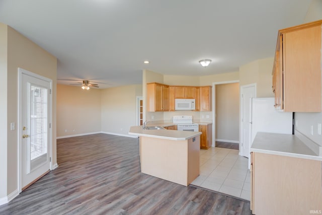 kitchen with open floor plan, white appliances, light countertops, and a peninsula